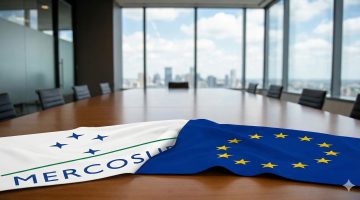 acordo Mercosul-UE, bandeiras dos dois grupos postas sob uma mesa
